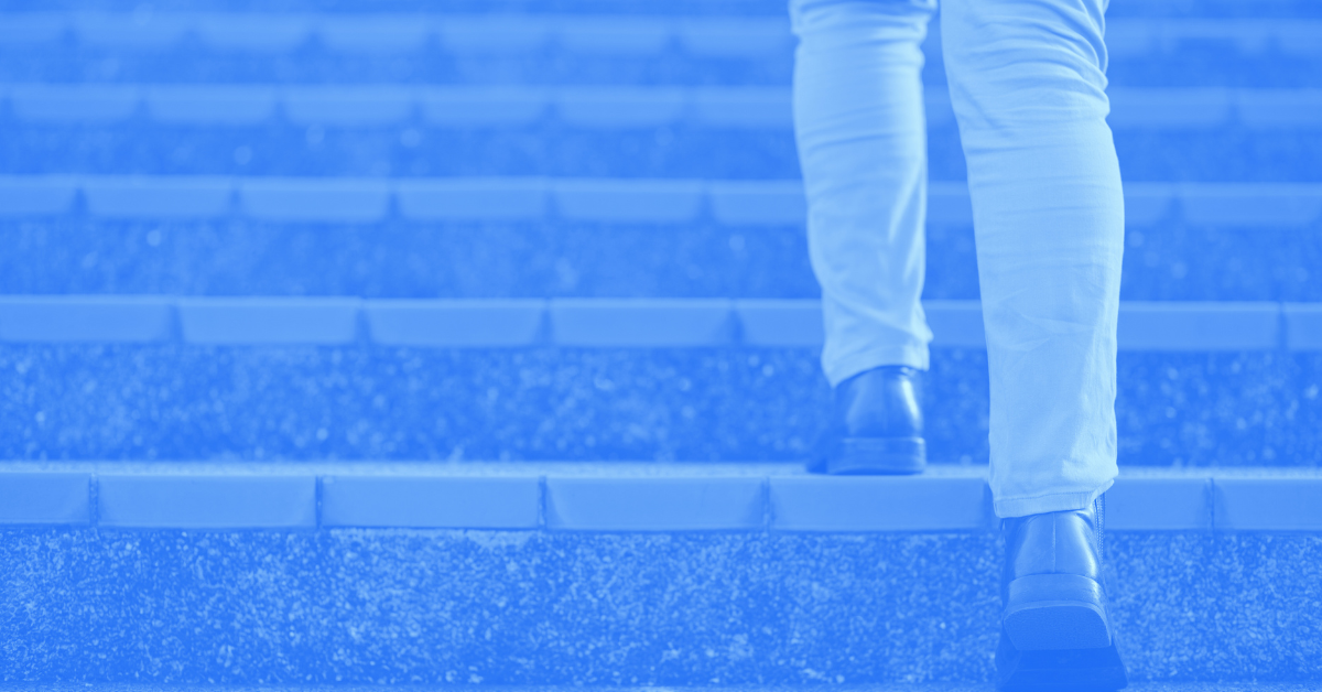 Back shot of person beginning to step up the stairs